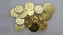 Gold coins, a safe-haven asset, arranged in a small pile