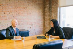 A professional woman and her accountant going through financial planning for business owners