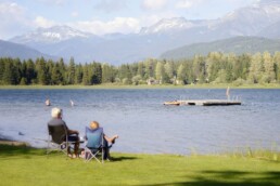 A senior couple sitting by a lake and enjoying retirement as they planned for market Volatility ahead of time