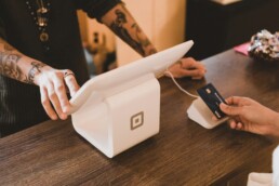 Hands using a credit card machine