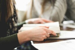 A woman reading a book to get a better understanding of financial jargon