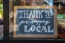 A welcome sign a business owner placed in their store's window after starting a business